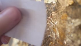 Thai Buddhists Stick figure gold leaf On the Buddha,The merit making on the important Buddha's day of the Thai people. - Powered by Shutterstock - Get 15% off with code: PIKWIZARD15