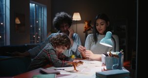 Happy asian family spending time at home togther. Young parents teaching their little kid with curly hair , having fun - happy family, togetherness concept 4k footage