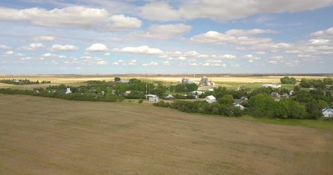 Small Canadian town in the middle of nowhere prairies and fields  Saskatchewan Manitoba Hazlet farming 4K flying drone aerial