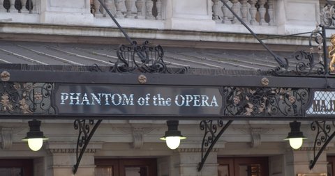 London / United Kingdom (UK) - 12 16 2019: Phantom of the Opera sign at Her Majesty's Theatre, close up panning shot