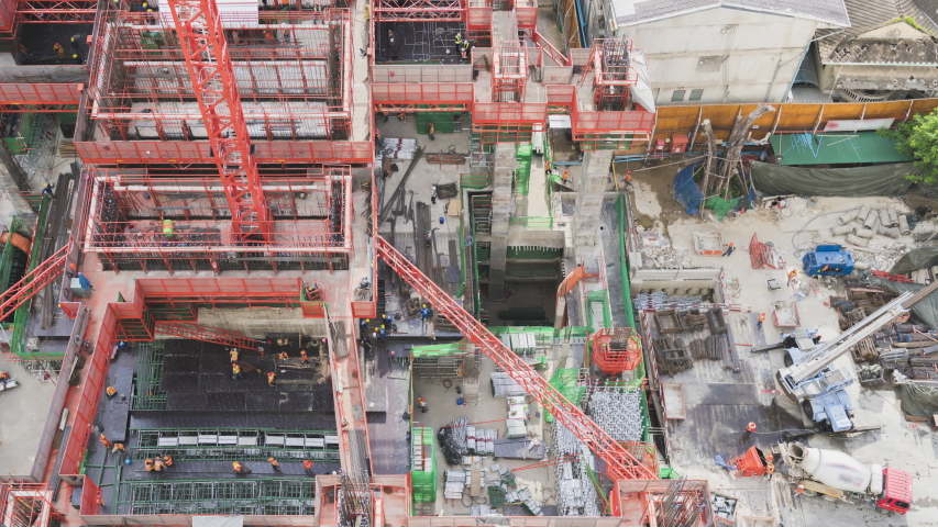 4k timelapse of  Aerial view of working Construction site Large construction site including several cranes working on a building area zoom view Royalty-Free Stock Footage #1052787971
