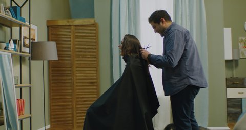 Man trying to give a haircut to his wife at home. Stay home, quarantine life. Shot on RED Helium with Atlas Orion 2x Anamorphic lens