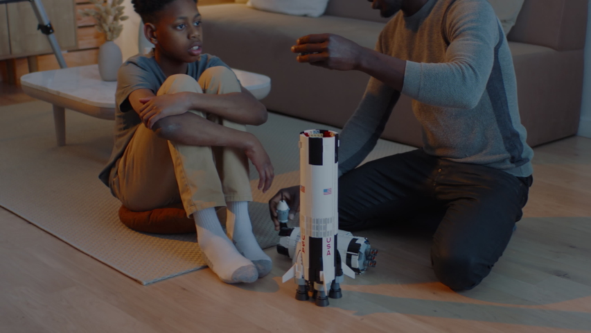 African American father and son playing together, building moon landing mission rocket together. Stay home, quarantine, science. ARRI Alexa Mini