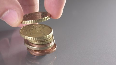 Stacking euro coins with different sizes building skyscraper