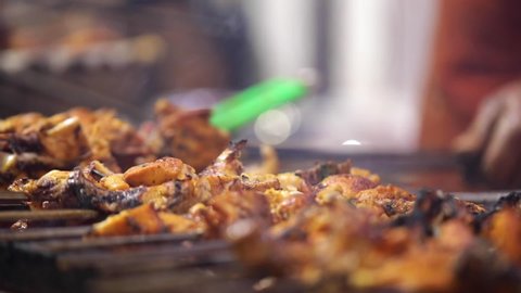 Closeup shot of roasting/Barbecuing kebab on skewer.Chicken tikka in preparation.