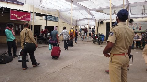 Bharuch,Gujarat/ India- May 20,2020: Migrant workers train in queue to home. Due to COVID 19 corona virus  lock down people travel. Policemen take prevention and social distancing. Railway. 