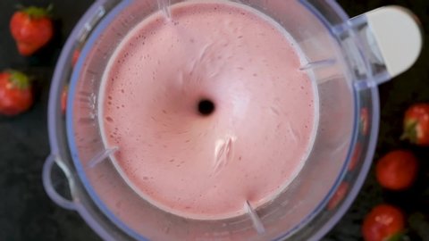 Slow motion strawberry shake mixing in blender. Top view. Healthy eating, healthy food concept
