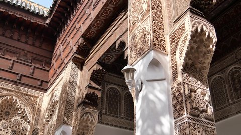 Moroccan architecture traditional arabian design - mosque entrance door. Slow motion POV in Marrakech
