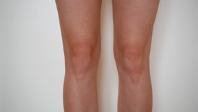 Woman knee massage after injury. Leg sprain pain. 4k video.