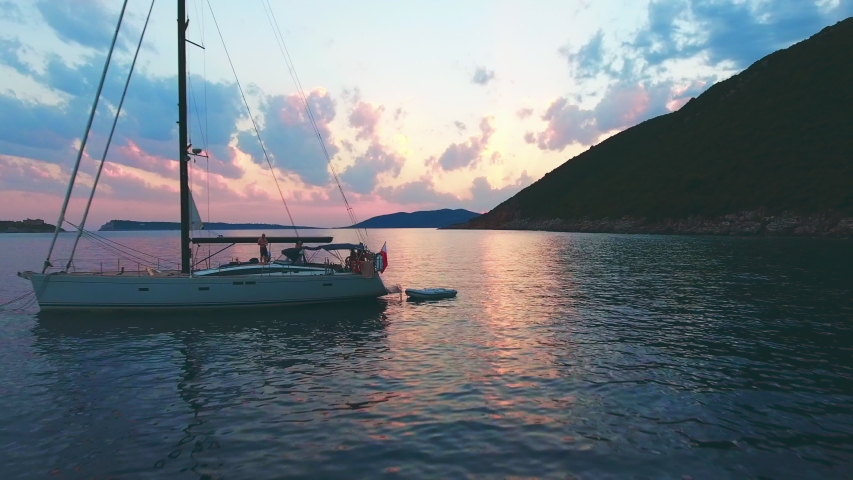 Beautiful calm sunset with only one yacht on the sea