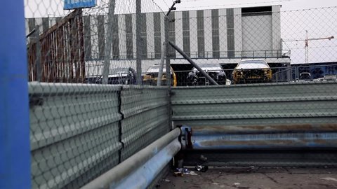 car recycling center through fence travelling