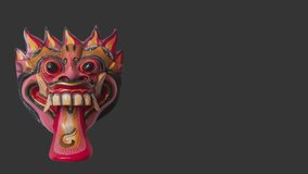 4K stop motion video of a wooden Balinese Barong Mask on black background. Handmade traditional mask from Bali. Demon or Angel from Indonesia screensaver.