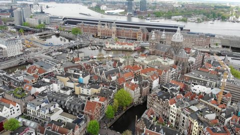 Aerial shot of a beautiful view from above of architectural buildings and Amsterdam canals. Netherlands in 4K
