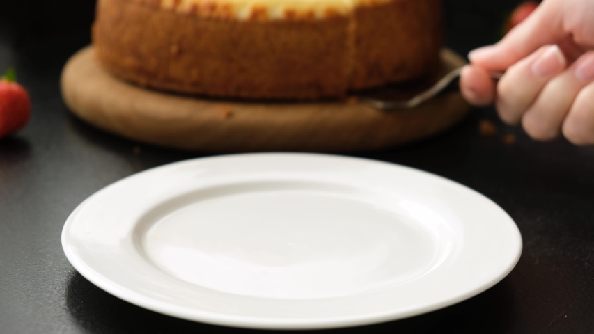 Serving cheesecake slice on plate. Classical new york cheesecake