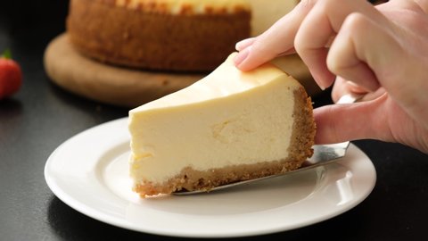 Serving cheesecake slice on plate. Classical new york cheesecake