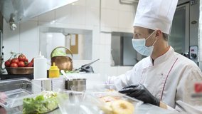 Food delivery in the restaurant. The chef prepares food in the restaurant and packs it. Panna cotta and vegetable salad in a plastic disposable containers - Powered by Shutterstock - Get 15% off with code: PIKWIZARD15