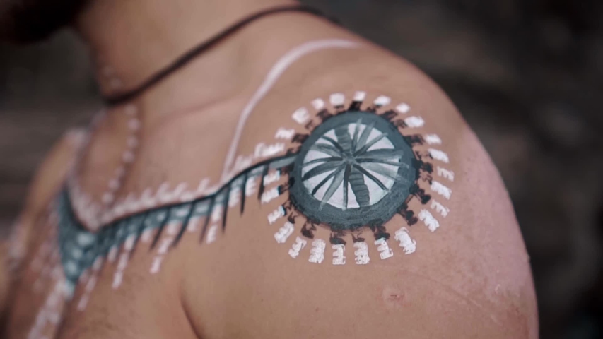 Young, handsome and courageous European man with drawings on his body
