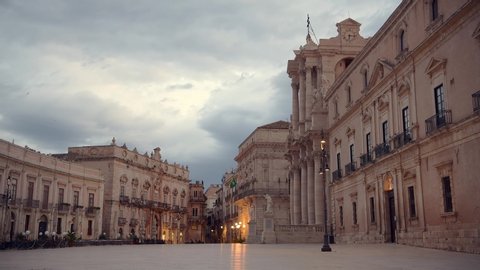 Empty square of Ortigia island in province Siracusa in Sicily at early cloudy sunrise