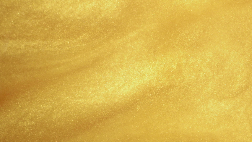 Macro photography of gold dust mixing in water. Close-up of gold spangles in the water Royalty-Free Stock Footage #1052828438