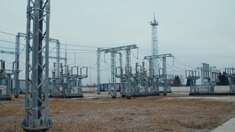 High voltage substation 110 kV with tall pylons and hog voltage distribution cables. Transformation station and electric power 
