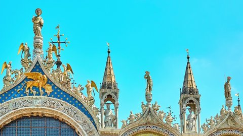 VENICE, ITALY - APRIL 25 2018: Detail of gable of Patriarchal Cathedral Basilica of Saint Mark showing patron apostle St. Mark with angels. Underneath is winged lion, symbol of saint and of Venice.