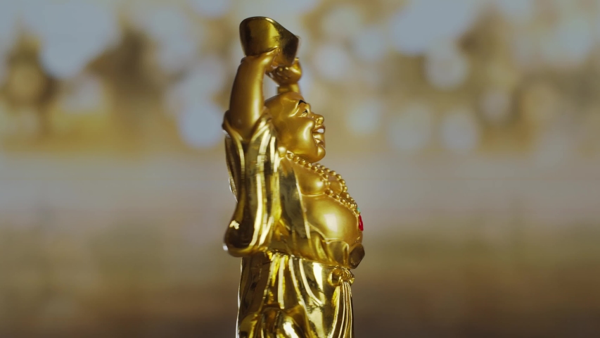 Golden figure Buddha Hotei god of communication, fun and well-being, rotates around an axis Royalty-Free Stock Footage #1052839214