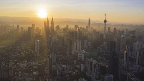 Aerial Kuala Lumpur cityscape dawn time lapse view of KL city skyline with busy streets and expressway of  Malaysia at sunrise. Pan up motion timelapse. Prores Full HD