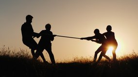 Family having fun in nature - playing tug-of-war - Powered by Shutterstock - Get 15% off with code: PIKWIZARD15