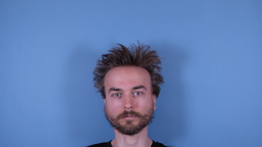 Stop motion animation funny face of bearded disheveled shaggy man and barber grooming hairdresser tools accessories on blue background. Barber shop, hairdresser, cutting hair at home.
