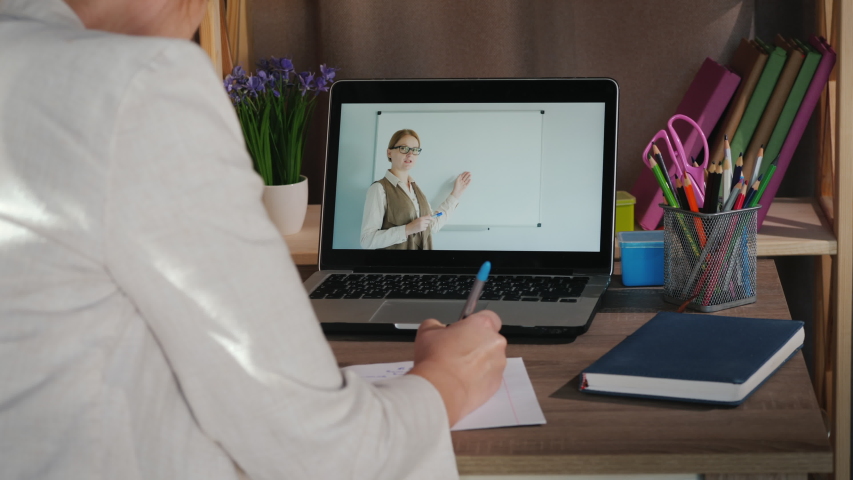 Female student studies at home near laptop, university online concept Royalty-Free Stock Footage #1052855876