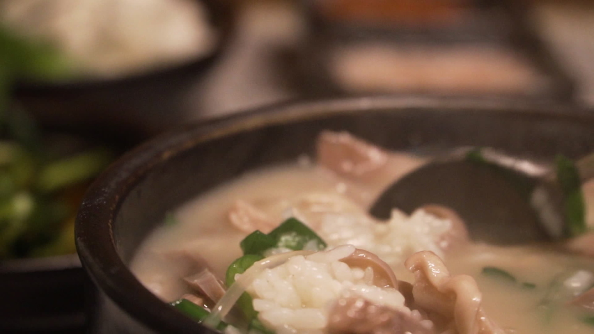 Korean traditional food, Pork and Rice Soup, Dwaeji-gukbap, Busan, South Korea. Royalty-Free Stock Footage #1052863211