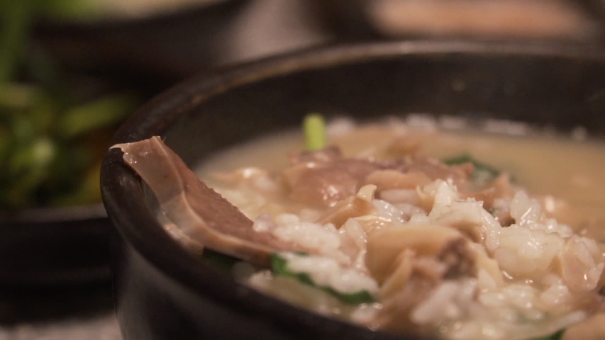 Korean traditional food, Pork and Rice Soup, Dwaeji-gukbap, Busan, South Korea. Royalty-Free Stock Footage #1052863214