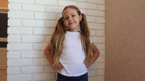 Funny little girl smiling looking at camera at home, cute kid talking to webcam making online video call or recording vlog having fun