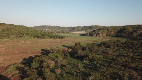 4K aerial drone video of green savanna hills and Avis Dam near historical railway bridge on main B6 road from Windhoek to Gobabis in central highland Khomas Hochland of Namibia, southern Africa