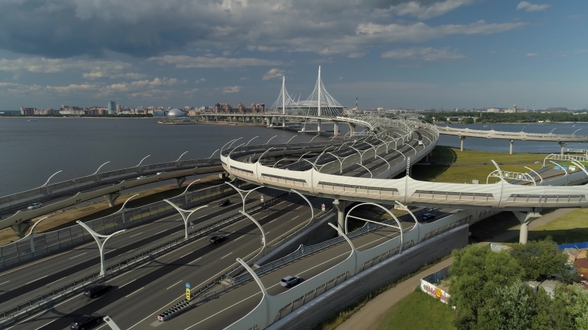 Cable-stayed bridge. High-speed track new modern futuristic highway Saint Petersburg roadway. Speed ​​diameter. Neva River. Active road junction traffic cars transportation. Logistics. Aerial forward Royalty-Free Stock Footage #1052864369