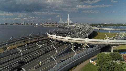 Cable-stayed bridge. High-speed track new modern futuristic highway Saint Petersburg roadway. Speed ​​diameter. Neva River. Active road junction traffic cars transportation. Logistics. Aerial forward