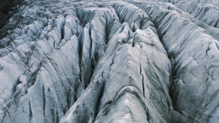 Flight over the Jökulsárlón, world wide famous glacial lagoon. Aerial landscape of glaciers between mountains in Iceland
