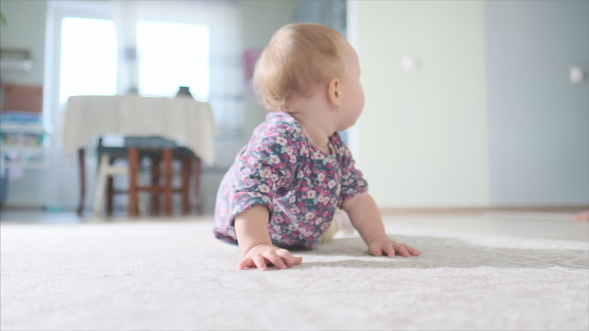 Happy baby crawls in the room. Infant baby plays with family in the house and learns how to crawl quickly during catch up games Royalty-Free Stock Footage #1052866055