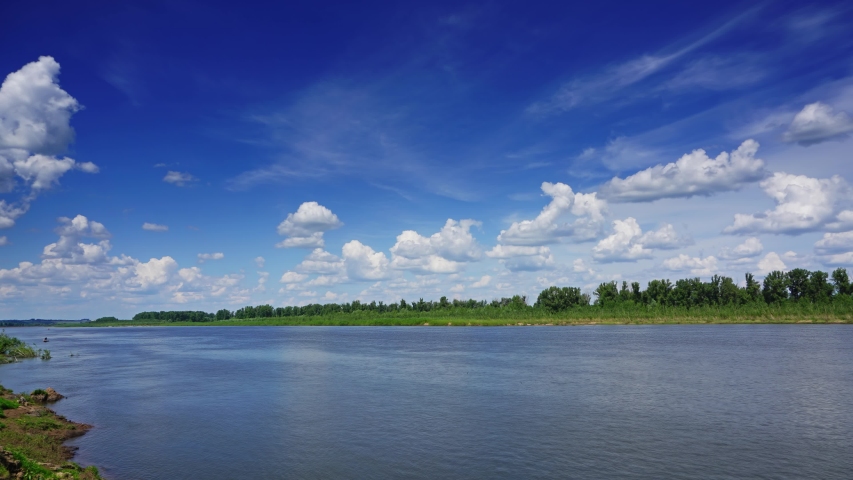 Landscape with clouds over river, timelapse 4k