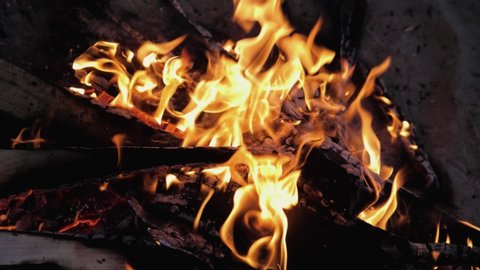 A bonfire burns. Close-up of flames. Summer evening. Slow motion.