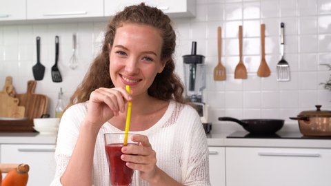 Healthy young woman drinking juice