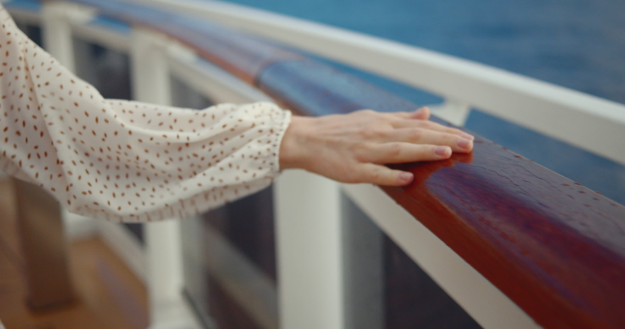 Female hand on the railing of the ship. Shot on Black Magic Cinema Camera Royalty-Free Stock Footage #1052883878