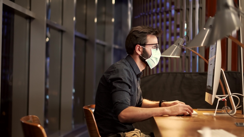 Businessman In Face Mask On Epidemic Coronavirus. Remote Working With Camera Chatting Colleagues Internet Online Meeting Conference Webinar. Distance Working Webcam.Man In Face Mask On Office Lockdown | Shutterstock HD Video #1052886941