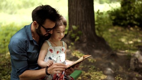 Cheerful Daughter Education Learn 
Read Book,Enjoying Father Family Lifestyle. Little Kid On Fathers Day. Happy Parent Dad Teach Adorable Cute Baby Girl Preschool Child. Daddy Reading Fairy Tale Story