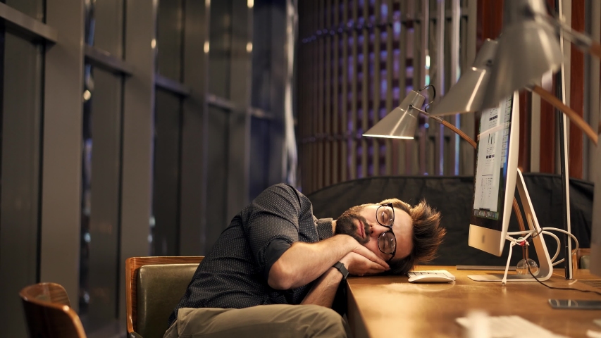 Overworked Businessman Sleeping On Workplace. Frustrated Businessman Daydreaming. Office Work Overtime. Workaholic Work In Internet Deadline. Tired Overwhelmed Exhausted Stressed Businessman In Office | Shutterstock HD Video #1052887559