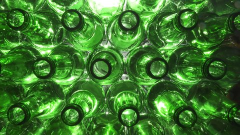 Empty bottles. Slider shot of empty glass bottles. Top view in production line. Empty green beer bottles, the top view ,Dolly shot, Shot in 4K UHD