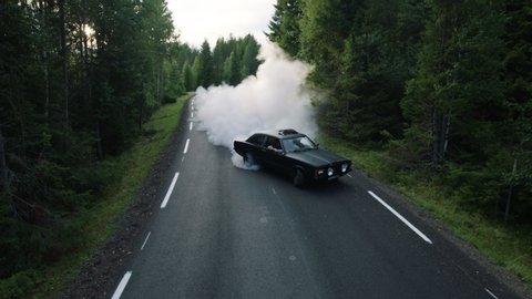 Car drifting on asphalt in the forest