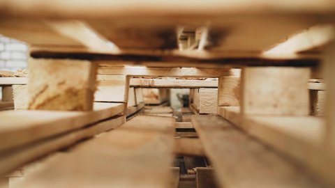 Wooden pallets in the factory. Shooting on the move. Close up. The movement of goods