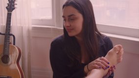 Close up - A young caucasian woman is giving her boyfriend a foot massage - Powered by Shutterstock - Get 15% off with code: PIKWIZARD15