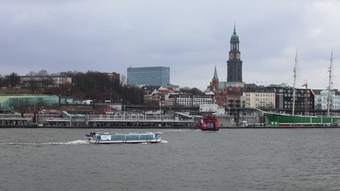 HAMBURG, GERMANY – 5 MARCH 2017: Pleasure boat sailing along the Elbe River near St. Pauli piers. The St. Pauli Piers are the largest landing place in the Port of Hamburg, Germany